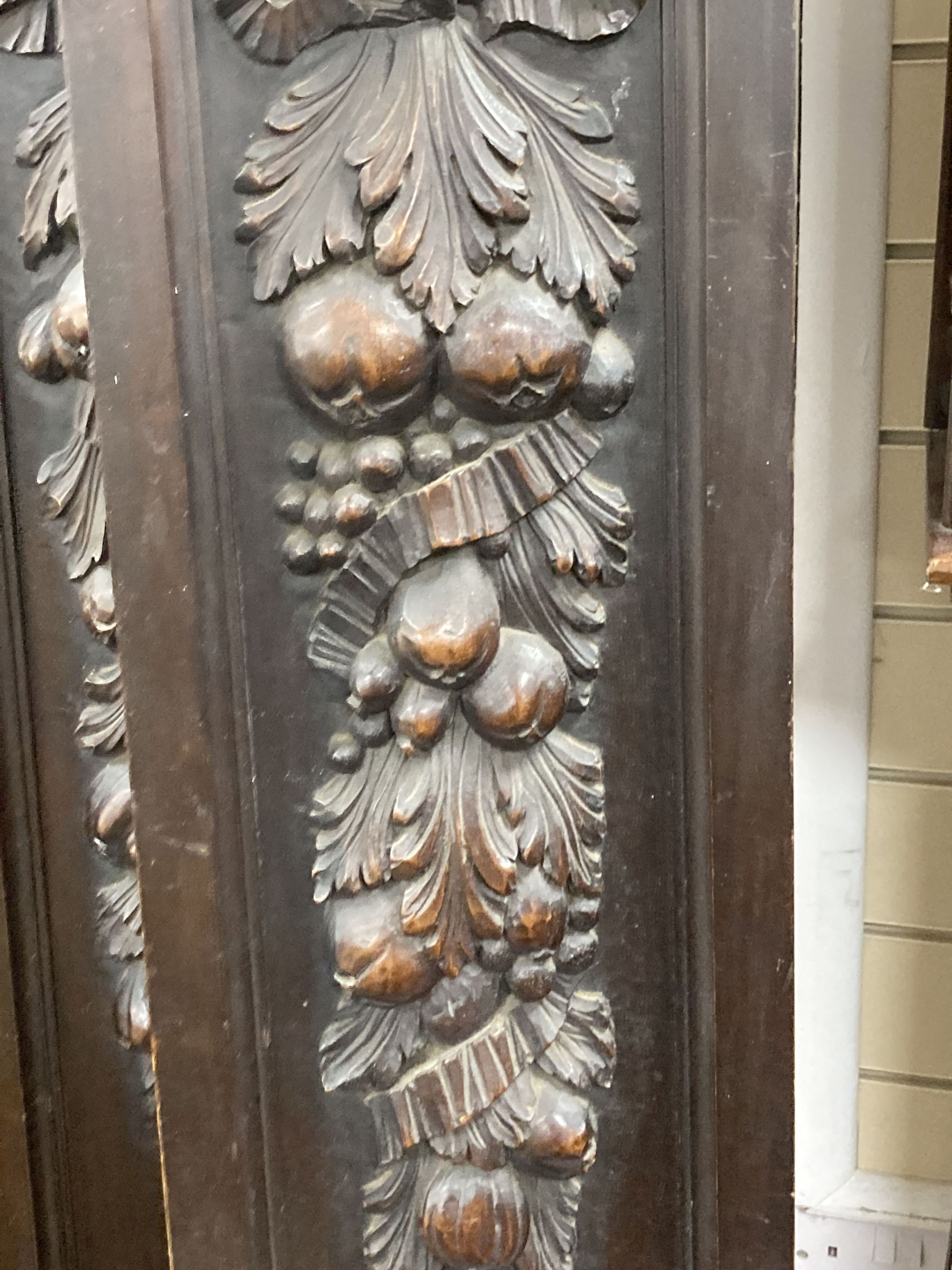 A pair of Austrian carved mahogany cabinet doors, circa 1900, width 25cm, height 192cm